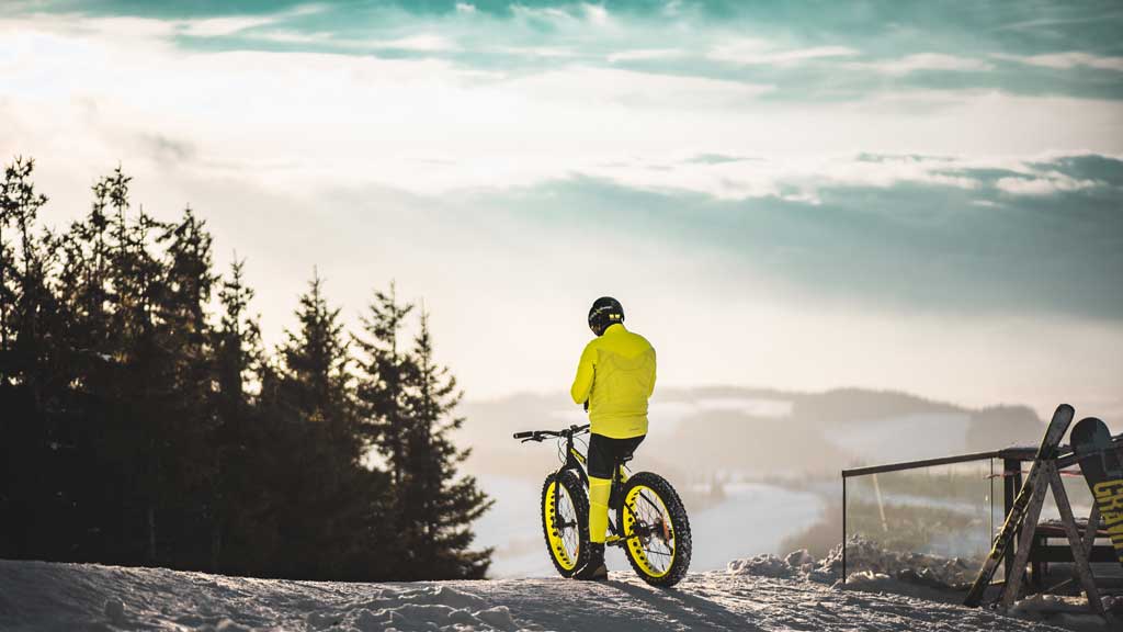 person on a mountain bike in the winter