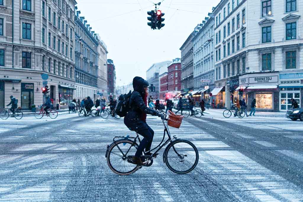 person riding an electric bike in the city during winter